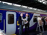 STORM Chairman Richard Greenwood receives a replica train headboard from Northern's Lee Wasnidge at the naming ceremony for 156466 on October 3rd 2009.  Alwyn Smith